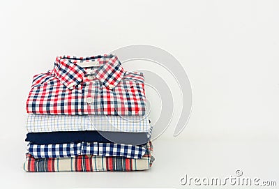 Stack of plaid shirts on white background Stock Photo