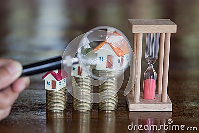 Stack coin and bar graph with grow, magnifying glass searching for a new home, Loan for real estate or save money for buy a house Stock Photo