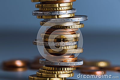Stack of coins close up with blurred background. Euro coins stacked in a pile. Soft focus Stock Photo