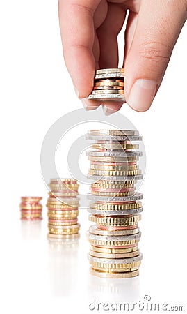 Stack coins with hand - increasing revenue Stock Photo