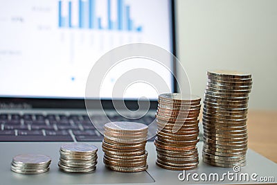 Stack coins on laptops Stock Photo