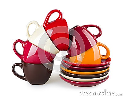 Stack of colorful mugs and saucers on white background Stock Photo