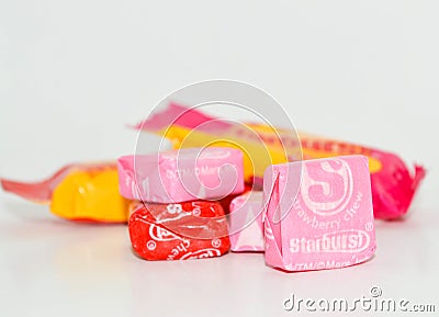 A stack of colorful Starburst candy with a pink in the front Editorial Stock Photo