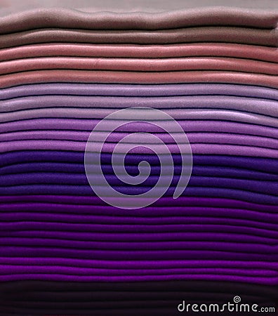 Stack of colorful t-shirts. Layers of colorful fabric. Stack of colorful folded clothes, multicolored background Stock Photo