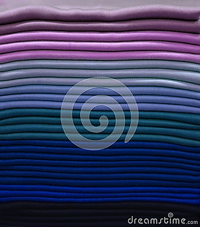 Stack of colorful t-shirts. Layers of colorful fabric. Stack of colorful folded clothes, multicolored background Stock Photo