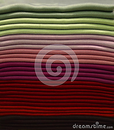 Stack of colorful t-shirts. Layers of colorful fabric. Stack of colorful folded clothes, multicolored background Stock Photo