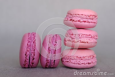Stack of delicious french pink fruity flavour macarons on grey background Stock Photo