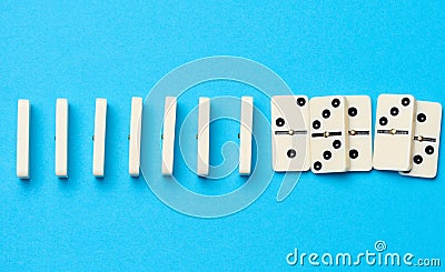 A stack of dominoes on a blue background, an intellectual game Stock Photo