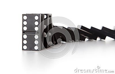 Stack of dominoes falling Stock Photo