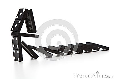 Stack of dominoes falling Stock Photo