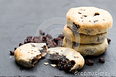 Stack of Eccles cakes on black stone background Stock Photo
