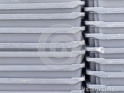 Stack of empty grey plastic fishery containers Stock Photo