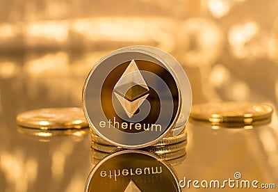 Stack of ethereum coins with gold background Editorial Stock Photo