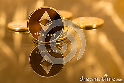 Stack of ethereum coins with gold background Editorial Stock Photo