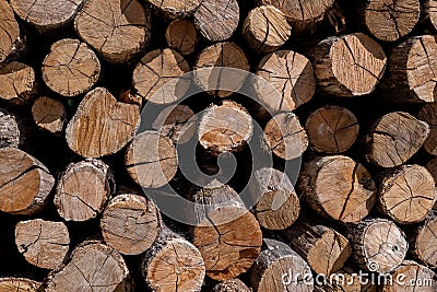 A stack of firewood lumber, the ends of logs Stock Photo