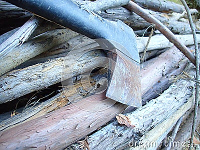 Stack of firewood wood sticks with axes on wood Stock Photo