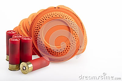 Stack of flying clay pigeon targets and shotgun shell bullets on white background , Gun shooting game Stock Photo