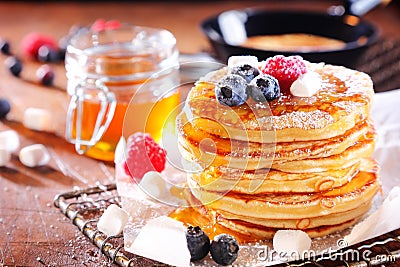 Stack of fresh golden pancakes or flapjacks Stock Photo