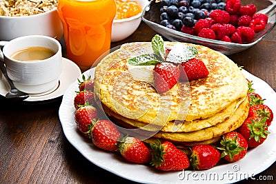 Stack of freshly prepared traditional pancakes with strawberries Stock Photo