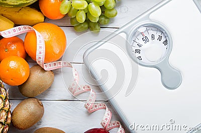 Stack of fruits, white weight scale and tailor meter Stock Photo