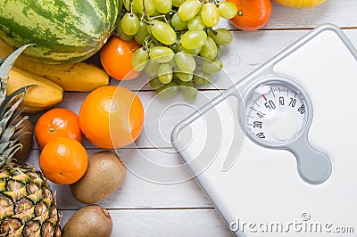 Stack of fruits and white weight scale Stock Photo
