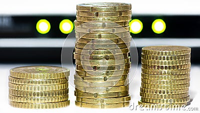 Stack of gold coins, like bitcoins, in front of network lights Stock Photo