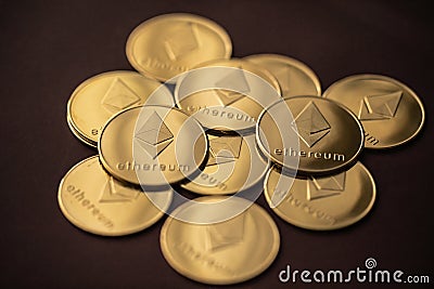 Stack of golden ether coins or Ethereum coins close up depicting cryptocurrency and digital money Editorial Stock Photo