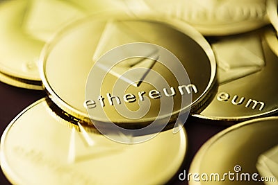 Stack of golden ether coins or Ethereum coins close up depicting cryptocurrency and digital money Editorial Stock Photo