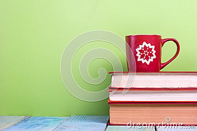 Stack of hardback books, diary on wooden deck table and green background. Back to school. Copy Space. Education Stock Photo