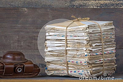 A stack of letters and a camera Stock Photo