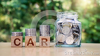 Stack many coins on a wooden block labeled cars. Stock Photo