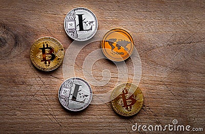 Stack of many shiny crypto coins on daylight in nature on wooden table background. Silver and golden coins of cryptocurrency on Editorial Stock Photo