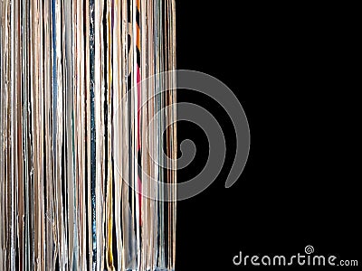 Stack of many vinyl records in old color covers on left side on photo on black background Stock Photo