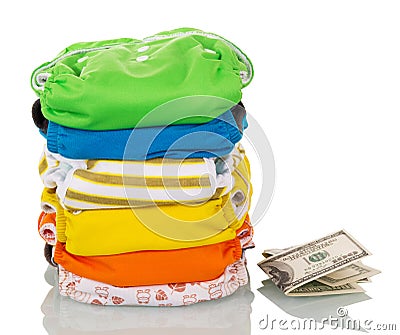 Stack modern eco-friendly diapers and money isolated on white. Stock Photo