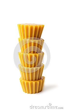 Stack of natural beeswax cake blocks on white background Stock Photo