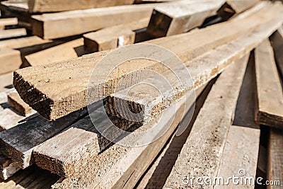 Stack of natural wooden boards on building site. Industrial timber for carpentry, building or repairing, lumber material for roofi Stock Photo