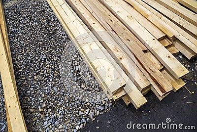 Stack of natural wooden boards on building site. Industrial timber for carpentry, building or repairing, lumber material for Stock Photo