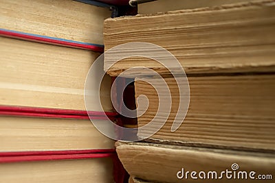 A stack of old books shooting up close. Ancient books in a stack. Old paper in books - a large stack - macrophoto. Stock Photo