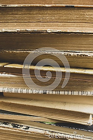 A stack of old books shooting up close. Ancient books in a stack. Old paper in books - a large stack - vertical photo. Stock Photo