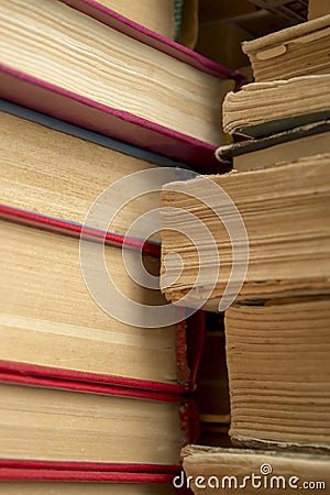 A stack of old books shooting up close. Old paper in books - a large stack - vertical photo. Ancient books in a stack. Stock Photo