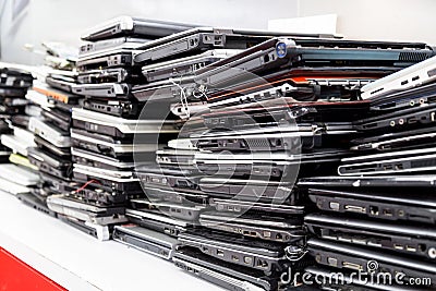 Stack of old, broken and obsolete laptop computer for repair Stock Photo