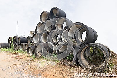 Stack of old concrete drain pipes Stock Photo