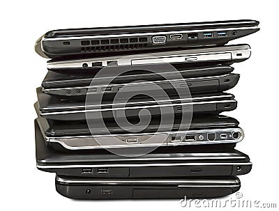 Stack of old laptops awaiting repair isolated on white backgroun Stock Photo