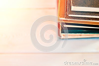 Stack of old used books on white wooden background. Pile of vintage old hardback books. Back to school. Copy space Stock Photo