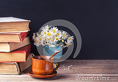 A stack of old vintage books lying on a wooden table. Country still life. Stock Photo