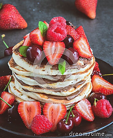 Stack of pancake with nutella and fresh berries Stock Photo