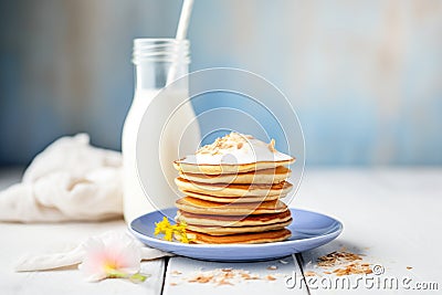 stack of pancakes with coconut milk dribble, side view Stock Photo