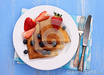 Stack of pancakes, fresh strawberry blueberry, cutlery Stock Photo