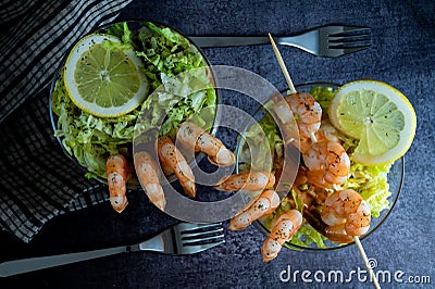 A stack of pancakes with pouring honey, fresh blueberry and strawberry and whip cream on top in plate on wooden table Stock Photo