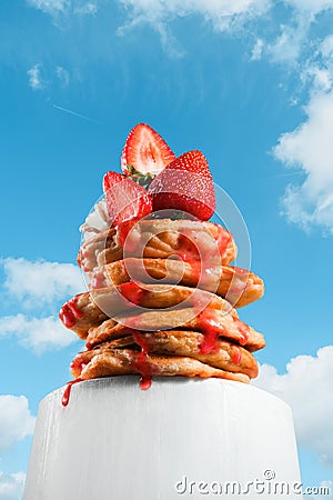 Stack of pancakes or tower of pancakes shot from below, perspective effect. Creative stack of pancakes with berries, strawberries Stock Photo